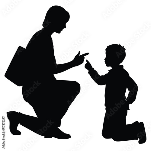 Mother or teacher kneeling and pointing at kneeling child