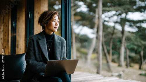 Confident Japanese Woman Working Remotely in a Scenic Environment