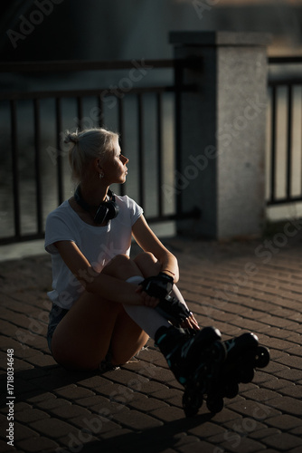 Young woman resting with roller skates