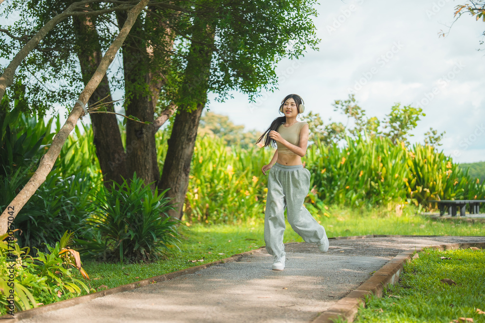 custom made wallpaper toronto digitalA sporty woman in sportswear exercises at the garden