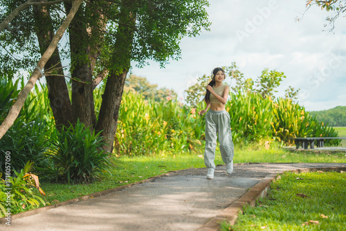 Wallpaper Mural A sporty woman in sportswear exercises at the garden Torontodigital.ca