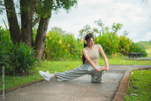 Wallpaper Mural A sporty woman in sportswear exercises at the garden Torontodigital.ca