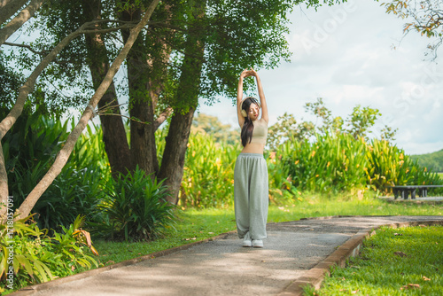 Wallpaper Mural A sporty woman in sportswear exercises at the garden Torontodigital.ca