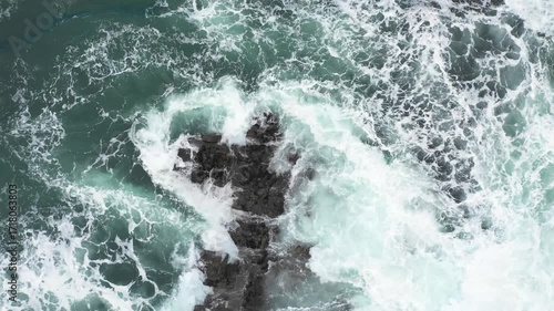 Aerial top view of rocks in the sea - Aerial video of majestic waves splashing on the rocks in Scotland - Travel and nature concepts