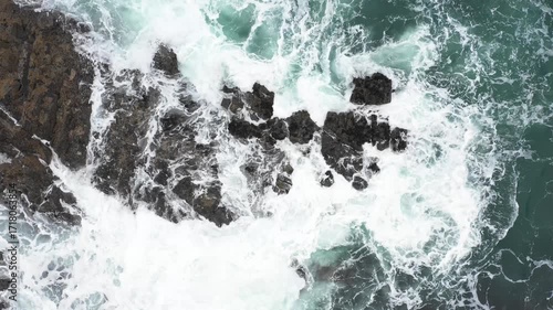 Aerial top view of rocks in the sea - Aerial video of majestic waves splashing on the rocks in Scotland - Travel and nature concepts