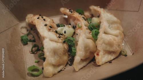 Crispy Dumplings With Sesame Seeds And Green Onions In Takeout Box