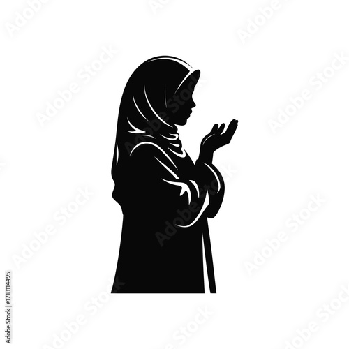 Silhouette of a woman in hijab offering prayers in a moment of reflection