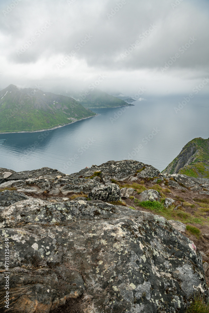 Obraz premium View from Barden mountain trail towards Medfjorden on the northwest of Senja island in arctic Norway. Hiking destination during cloudy summer day on Senja island. Outdoor travel destination.