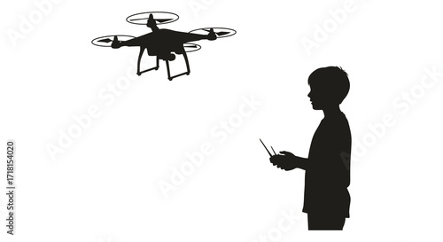 Silhouette of a boy operating a drone with a remote controller