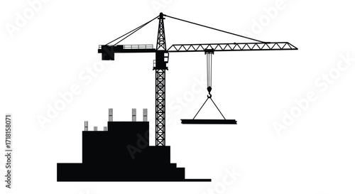 Black silhouette of a construction crane lifting materials near a building