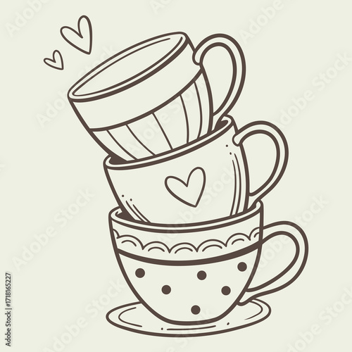 A stack of three teacups with heart and dot patterns on a beige background