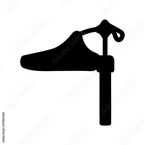 Black silhouette icon of a shoe placed on a shoe stretcher machine