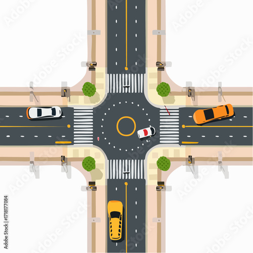 Top-down aerial view of a city street intersection with a roundabout, cars, and pedestrian crosswalks.