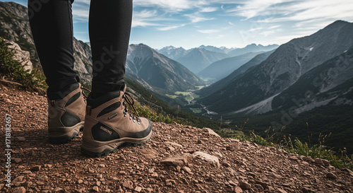 Hiker Standing on Mountain Trail with Scenic View