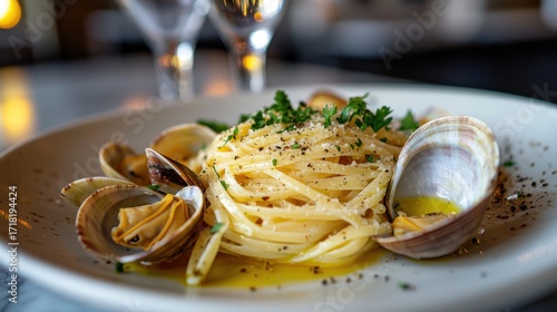 Premium clam pasta linguine alle vongole with fresh shellfish, herbs, and olive oil drizzle served on elegant white plate at upscale restaurant