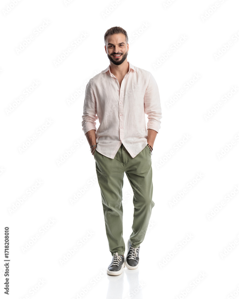Fototapeta premium happy young man looking forward and smiling while moving forward
