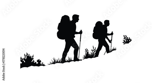Silhouettes of hikers walking uphill with backpacks and trekking poles