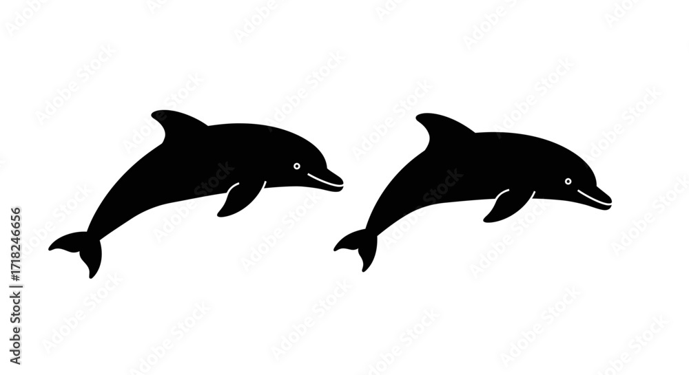 Fototapeta premium Two silhouetted dolphins leaping together gracefully in the ocean waters