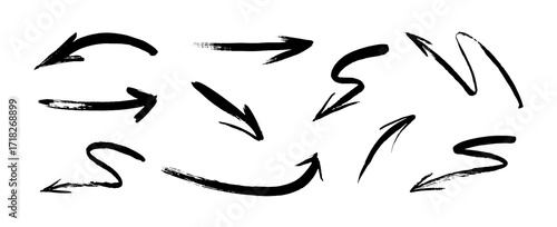 Set of hand-drawn arrows in a grunge black ink brush stroke style for navigation signs and doodle design elements, isolated on white background, vector illustration.