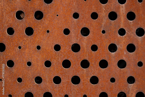 Rusty metal sheet with circular perforations

