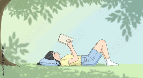 Young Woman Reclining Under A Tree Reading A Book During A Sunny Afternoon