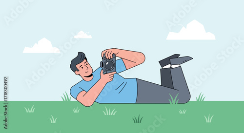 Photographer Capturing Landscape While Reclining on Green Field Under Azure Sky