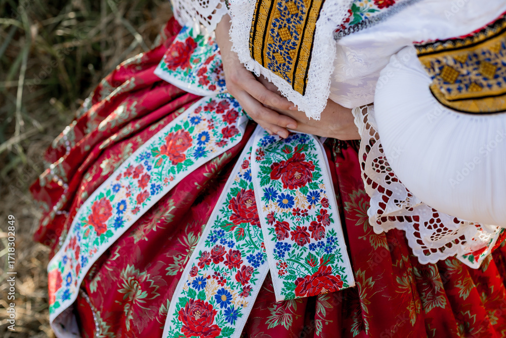 Naklejka premium Traditional czech folk costume (kroj), cultural heritage from the Czech Republic (Czechia, Southern Moravia, Central Europe), the woman wearing the national dress (costume, attire, clothing).
