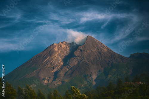 View of the volcano Mount Merapi emitting smoke in the morning with dramatic effect.
