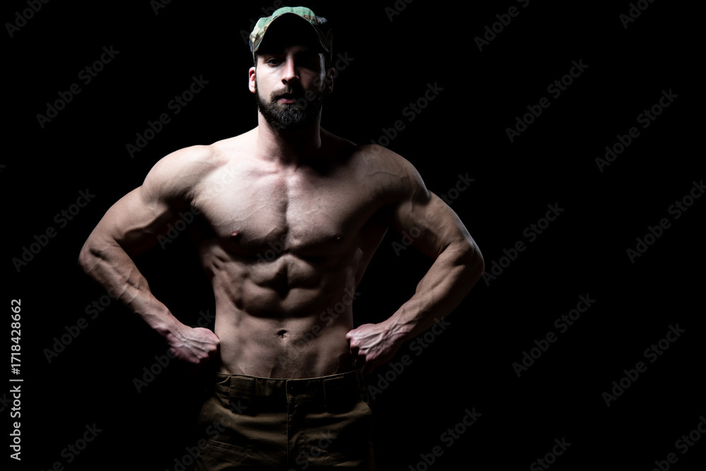 Fototapeta premium Portrait of a Bodybuilder Isolate on Black Blackground