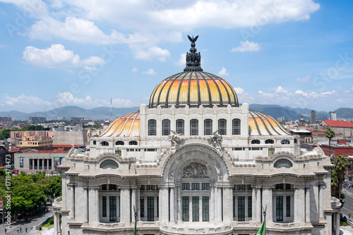 The building is a large, ornate structure with a dome on top. The dome is painted in bright colors, giving the building a sense of grandeur. Palace of Fine Arts, Mexico City, Zocalo, Bellar Artes