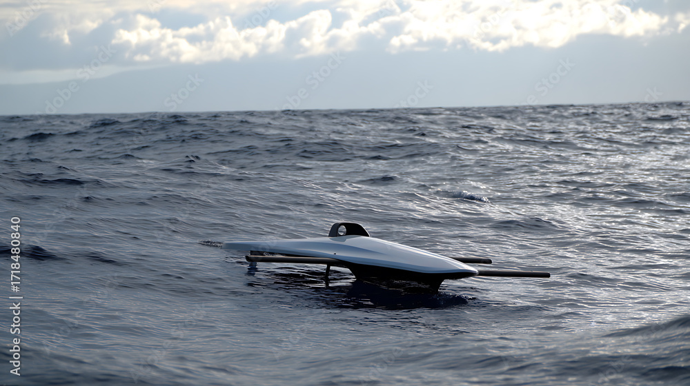 Naklejka premium Autonomous underwater vehicle floating on the ocean surface under cloudy sky