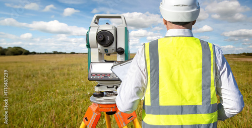 Surveyor in hard hat and sa...