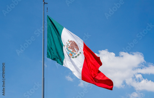 A flag with a white background and red and green stripes. The flag is waving in the wind. Decoration to celebrate Independence Day in Mexico, zocalo