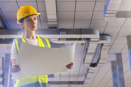 Woman engineer beneath vent...