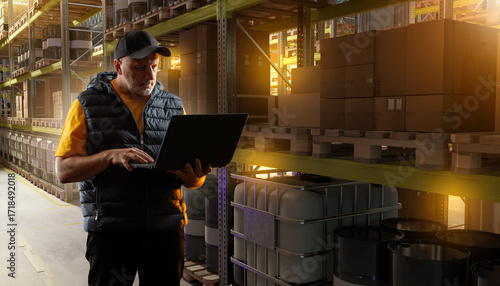 Warehouse worker using lapt...