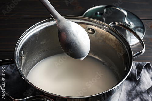 Canvas Print Sweet Coconut Sauce Coating the Back of a Spoon: Dessert sauce made of coconut m