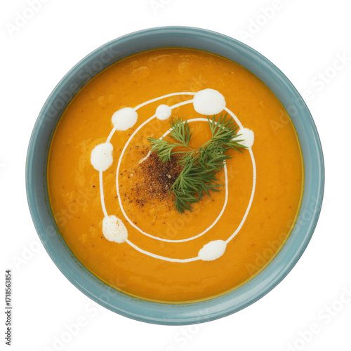 Bowl of creamy orange soup with swirl and garnish isolated on transparent background