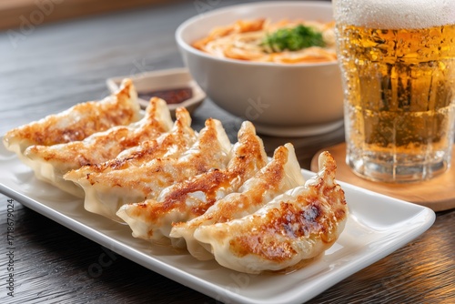 gyoza dumplings with dipping sauce and ramen japanese noodle, beer