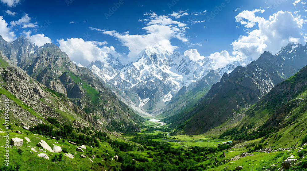 Fototapeta premium Breathtaking view of snow capped mountain range surrounded by lush green valleys and clear blue skies, evoking sense of tranquility and awe