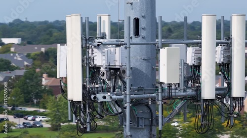 Aerial orbit view of mobile phone cell tower against residential houses