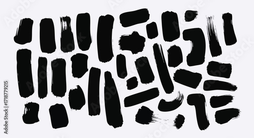 Dynamic black brush strokes scattered across a crisp white background offer modern artistic flair and abstract design elements for creative projects
