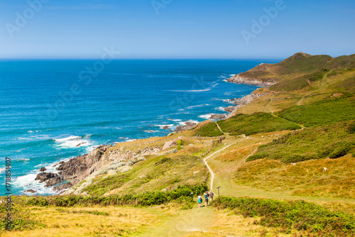 Woolacombe, Devon, England, UK - People walking on the South West Coast Path heading towards Morte Point, on one of the hottest days of the year.