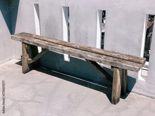 Simple rustic wooden bench on a terrace with natural texture