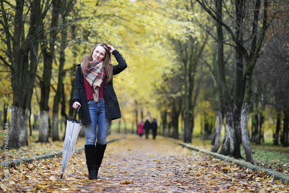 Fototapeta premium Young girl on a walk in the autumn park