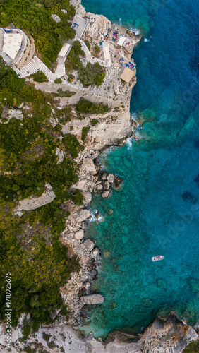 Wallpaper Mural Zakynthos Greece Blue Caves aerial photo showing turquoise Ionian Sea rocky cliffs boats by the coast and windmill landmark close to shoreline Torontodigital.ca
