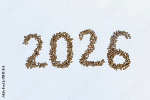 Calendar 2026 from Dry pet food on a white background. Granules of good nutrition for dogs and cats. Food for the animals. Brown homogeneous pieces of dry food in the shape of numbers