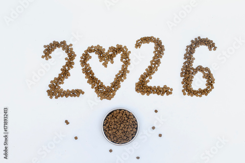 Calendar 2026 from Dry pet food on a white background. Granules of good nutrition for dogs and cats. Food for the animals. Brown homogeneous pieces of dry food in the shape of numbers