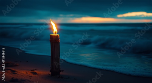 Tiki Torch Burning at Sunset on a Serene Beach With Gentle Waves