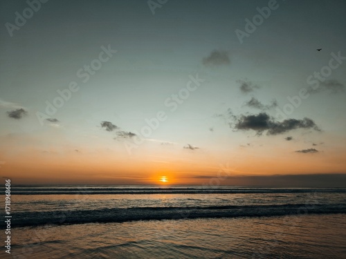 Seascape view during golden hour with calm waves.