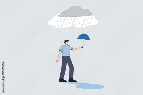 Business disaster, drenched businessman standing wet under an umbrella on rainy day.